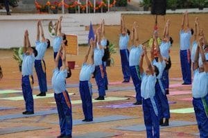 school children doing yoga