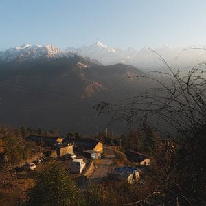 a view of a mountain range with a village in the foreground