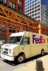 A fedex truck parked on the side of the road