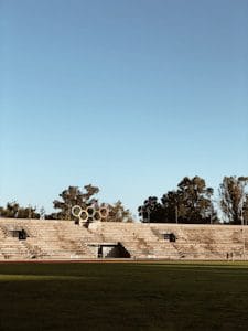 empty stadium with green grass field during daytime
