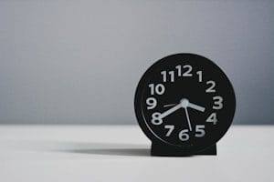 black round analog clock at 3.40
