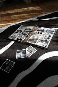 an open photo album laying on top of a zebra print blanket