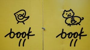 two yellow colored pages with black writing and drawing on them
