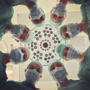 a circle of medical professionals in an operation theater