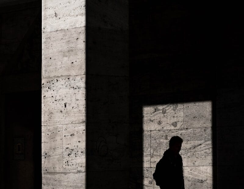 silhouette of man standing inside structure