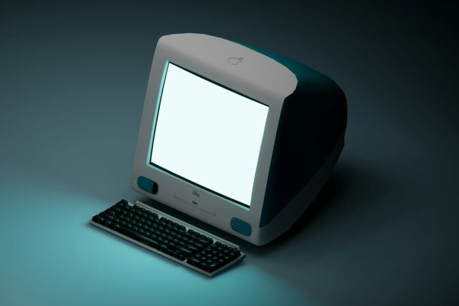 a computer with a white screen sitting on a table