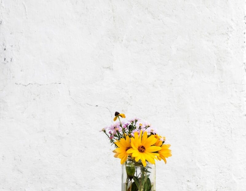 sunflower with clear glass vase on gray table