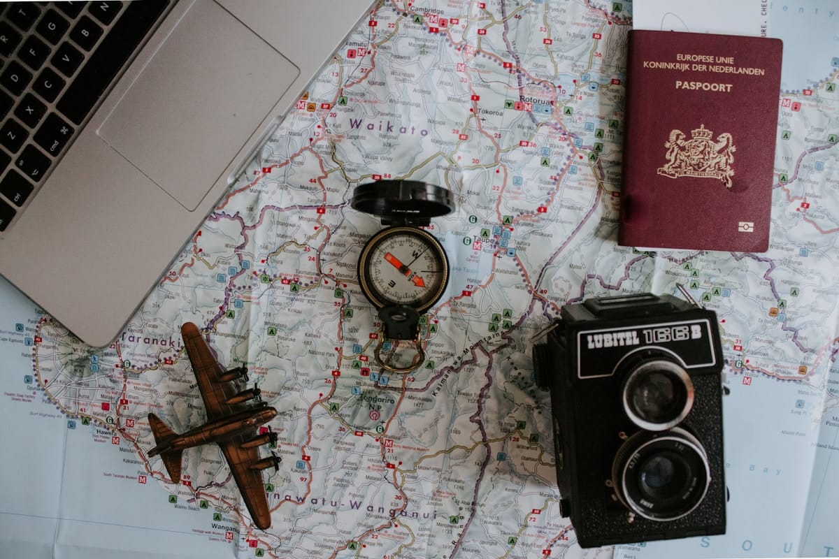 black twin-lens reflex camera, map and a passport on a world map