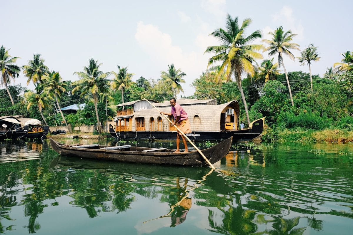 man riding on boat during daytime in Kerala