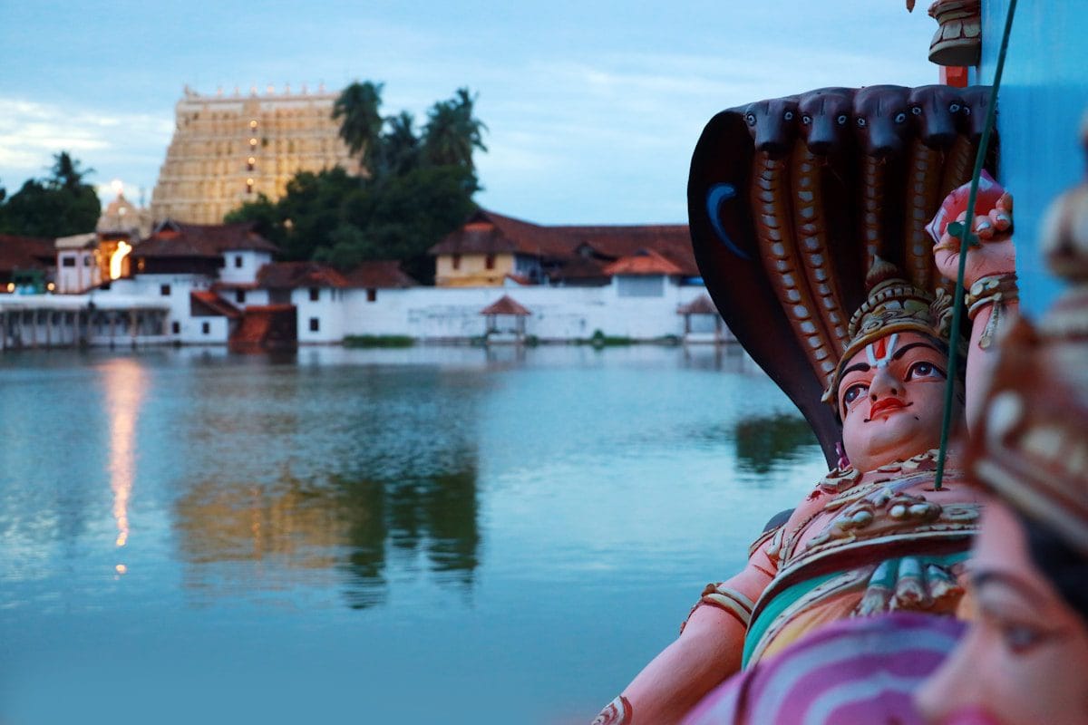 a statue next to a body of water near the Sree Padmanabha swami temple in Trivandrum