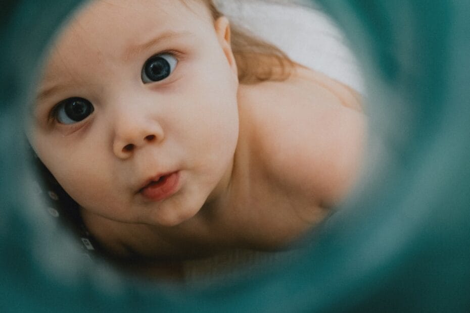 a close up of a baby looking at the camera